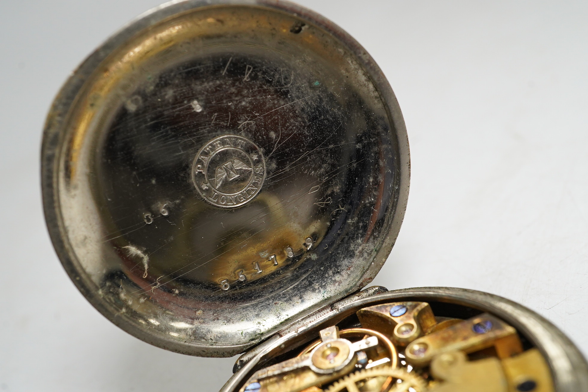 An early 20th century Longines base metal keyless pocket watch. Condition - poor, movement not going